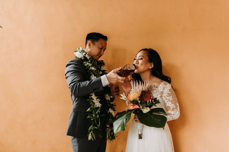 A Woman In Wedding Dress Drinking A Wine