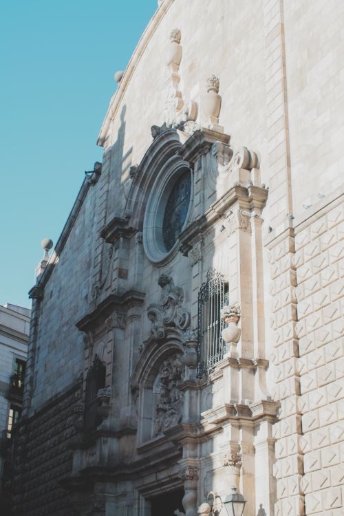 Free Elegant baroque facade of Church of Betlem in Barcelona illuminated by sunlight. Stock Photo