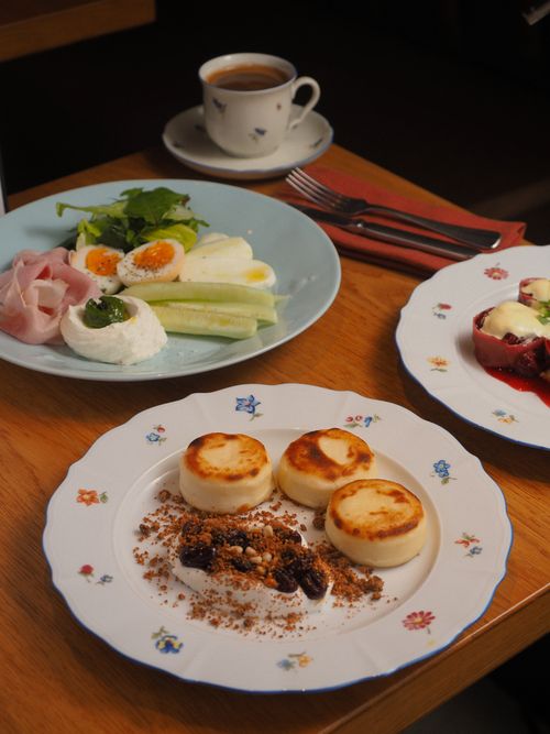 Free Delicious gourmet breakfast with eggs, cheese, and coffee on elegant dishes. Stock Photo