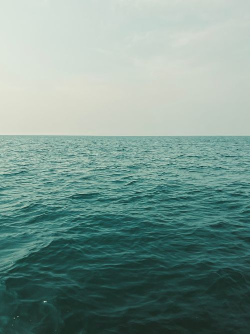 Free Calm sea with gentle waves under a bright sky. Perfect for relaxation themes. Stock Photo