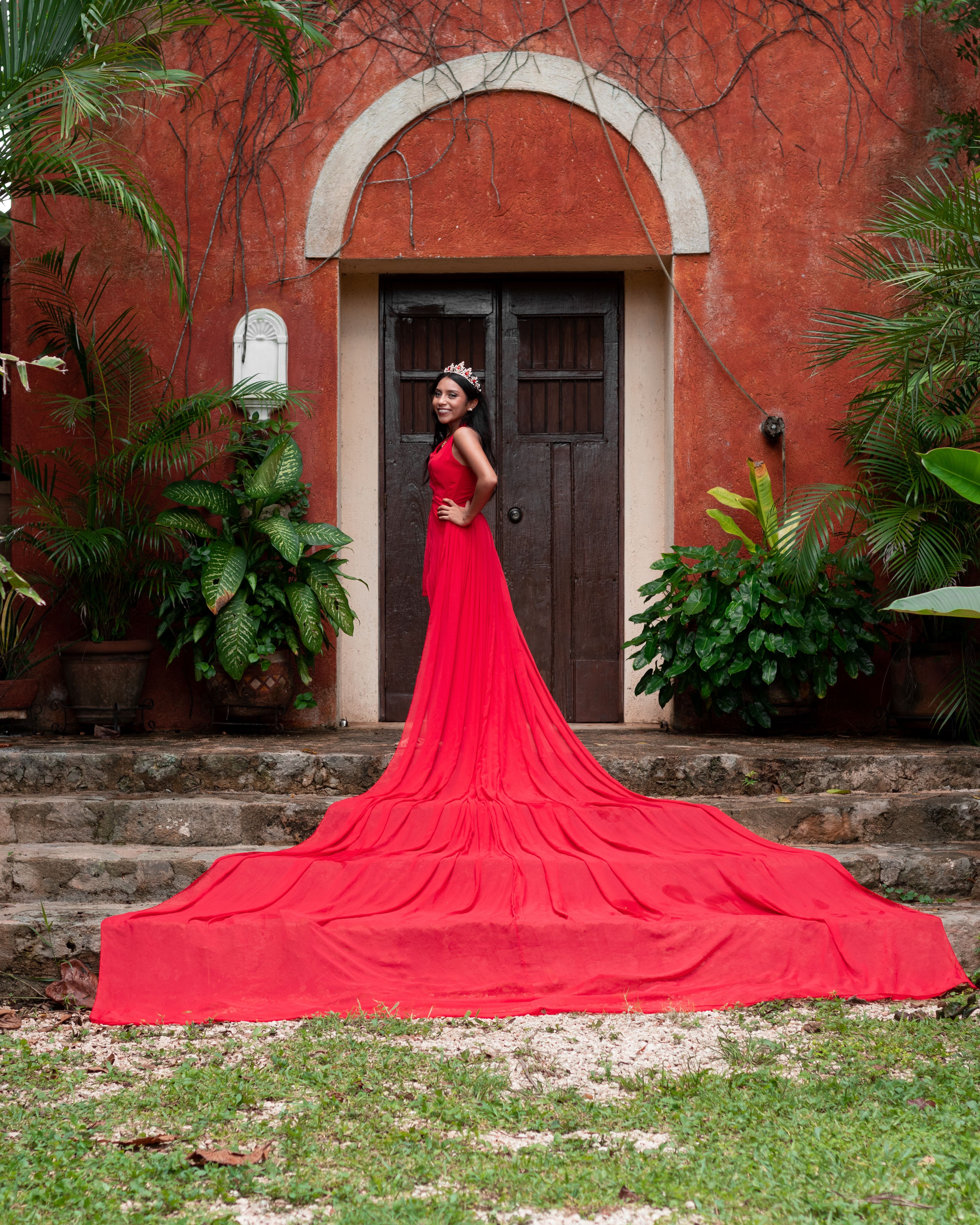 Woman Wearing Red Dress and Crown in Front of a Building · Free Stock Photo