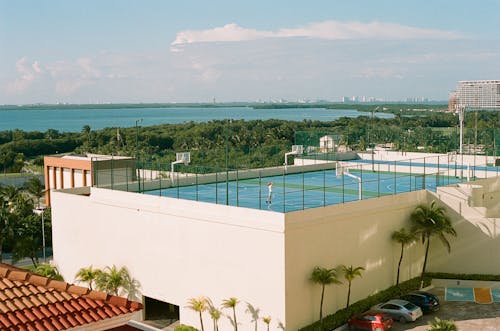 A pool with a view of the ocean and a building