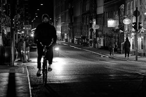 Grayscale Photo of Man Riding a Bicycle
