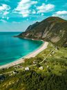 Aerial View of Shore Beside Green Mountains