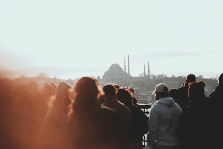 Crowd Of People On Bridge Overlooking Cityscape Of Istanbul