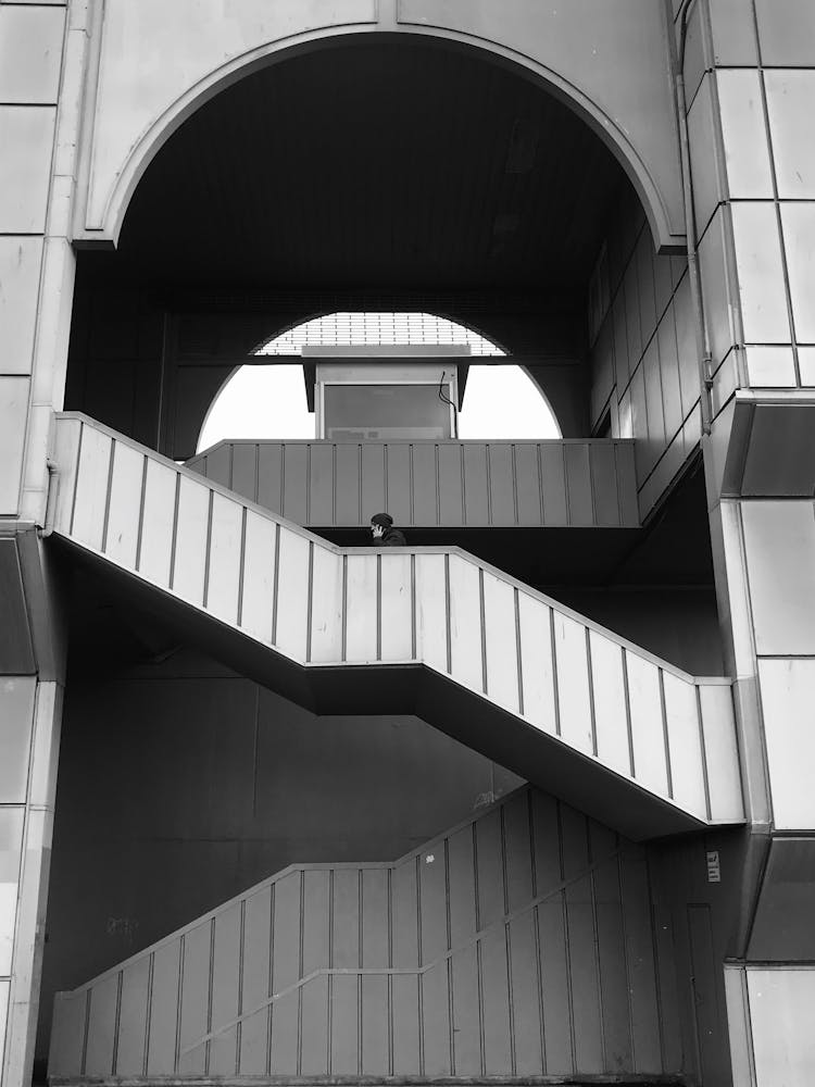 Person Walking Up The Stairs Of A Building