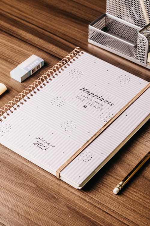 Free Stationery Around a Planner on a Desk Stock Photo