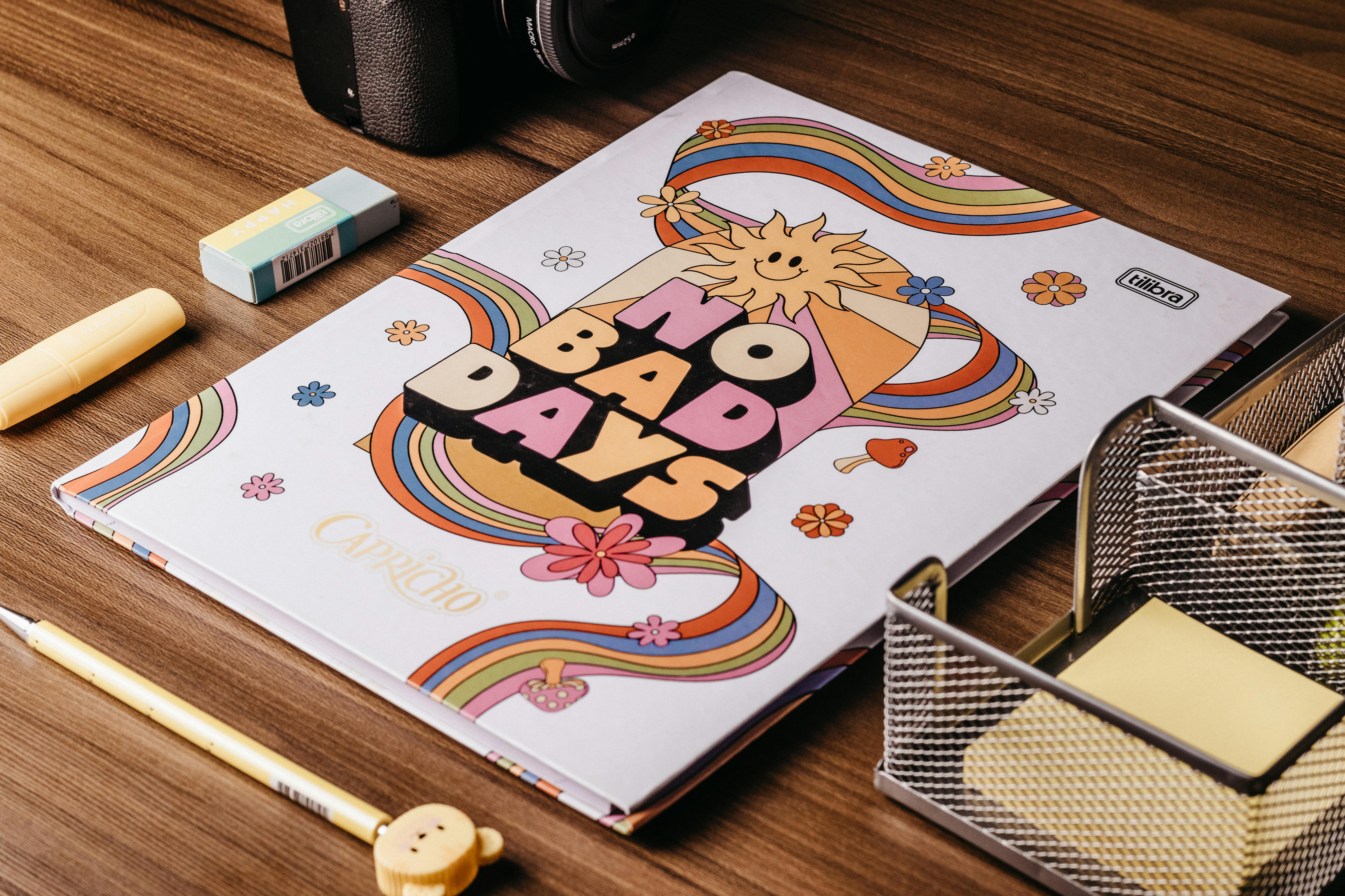 Colorful Paper Notebook Lying on Wooden Table · Free Stock Photo