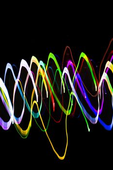 Colorful abstract light trails creating a vivid pattern against a dark backdrop.
