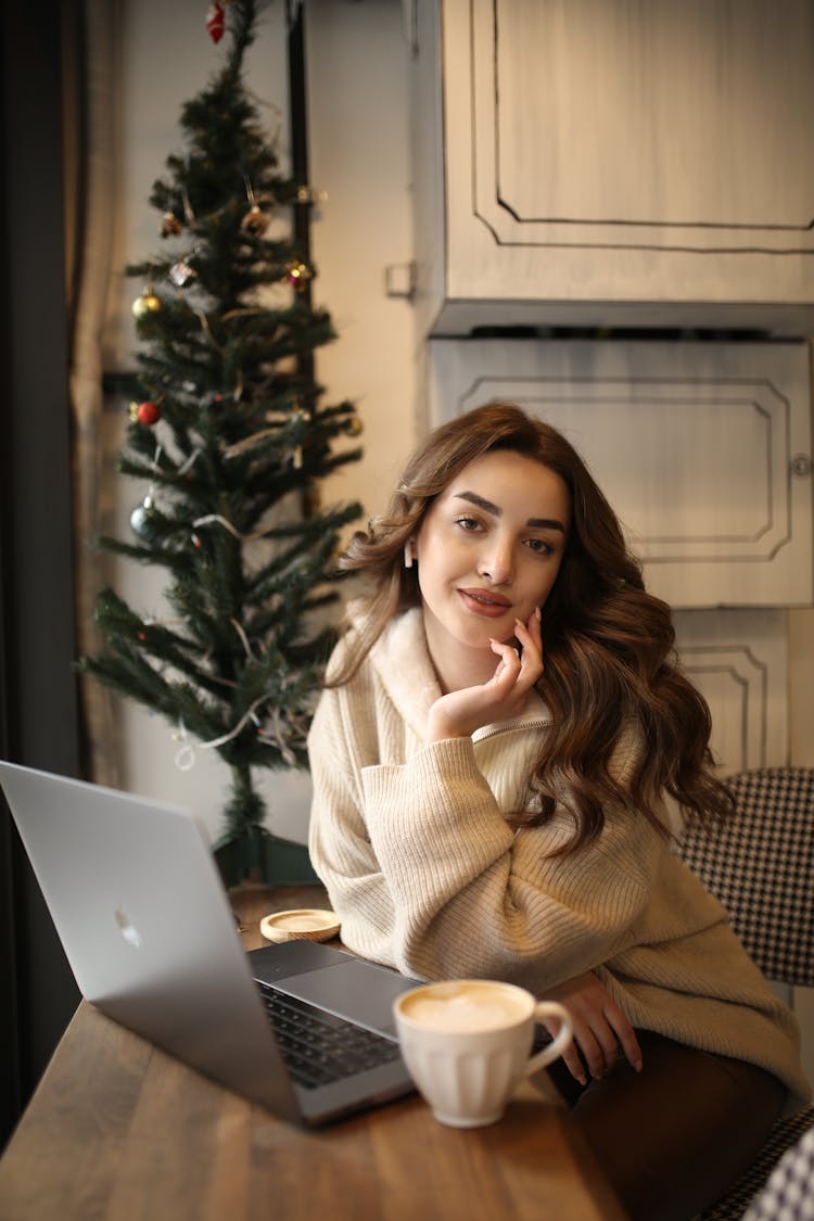 A Woman Sitting With A Laptop