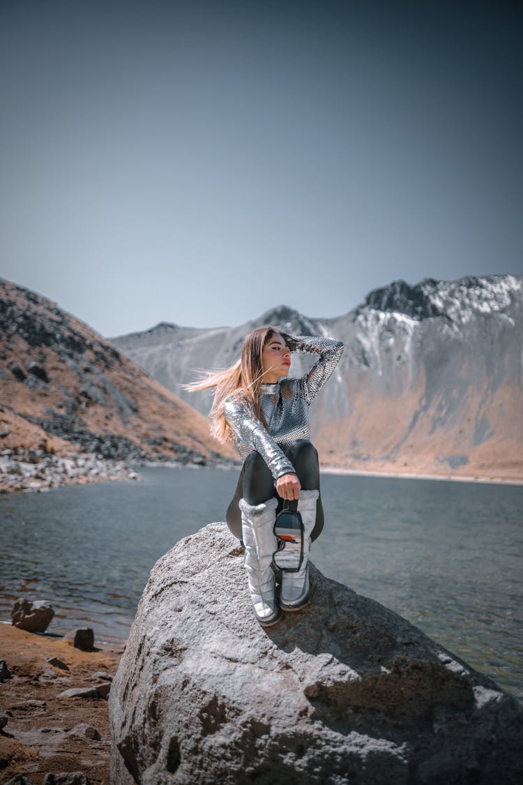 Glamour Woman Sitting On Rock In Mountains Landscape