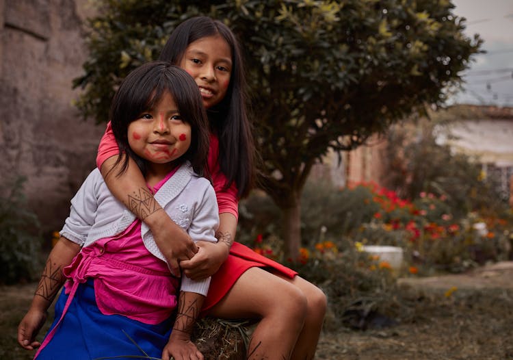 Indigenous Girls Posing Together In Garden