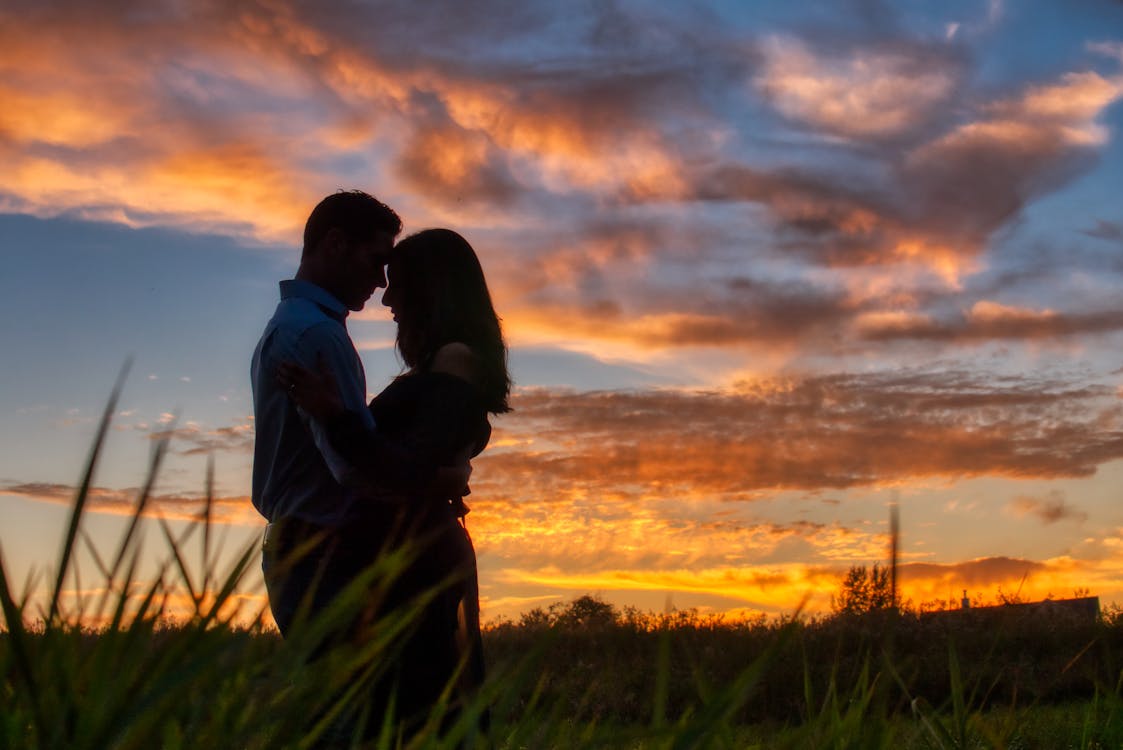 Photo of Couple Hugging During Dawn