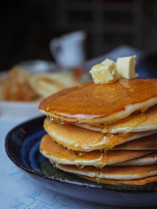 Free Mouthwatering pancakes stacked with syrup and butter, perfect breakfast meal. Stock Photo
