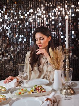Sophisticated woman enjoying a luxurious meal in a stylish restaurant setting.
