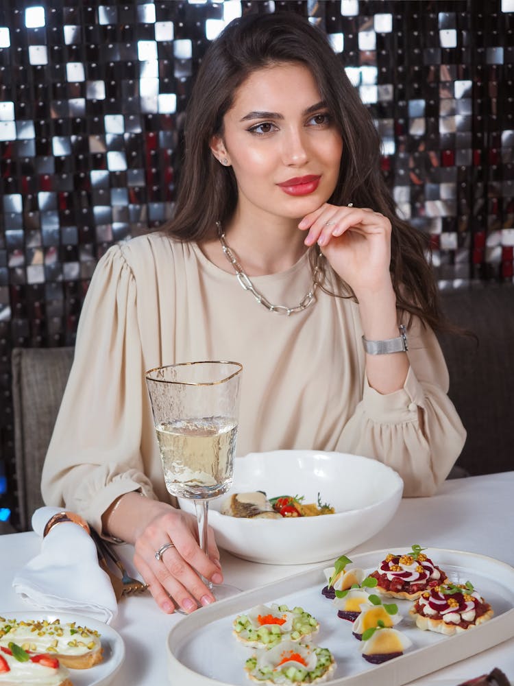 Portrait Of A Woman Sitting At A Table