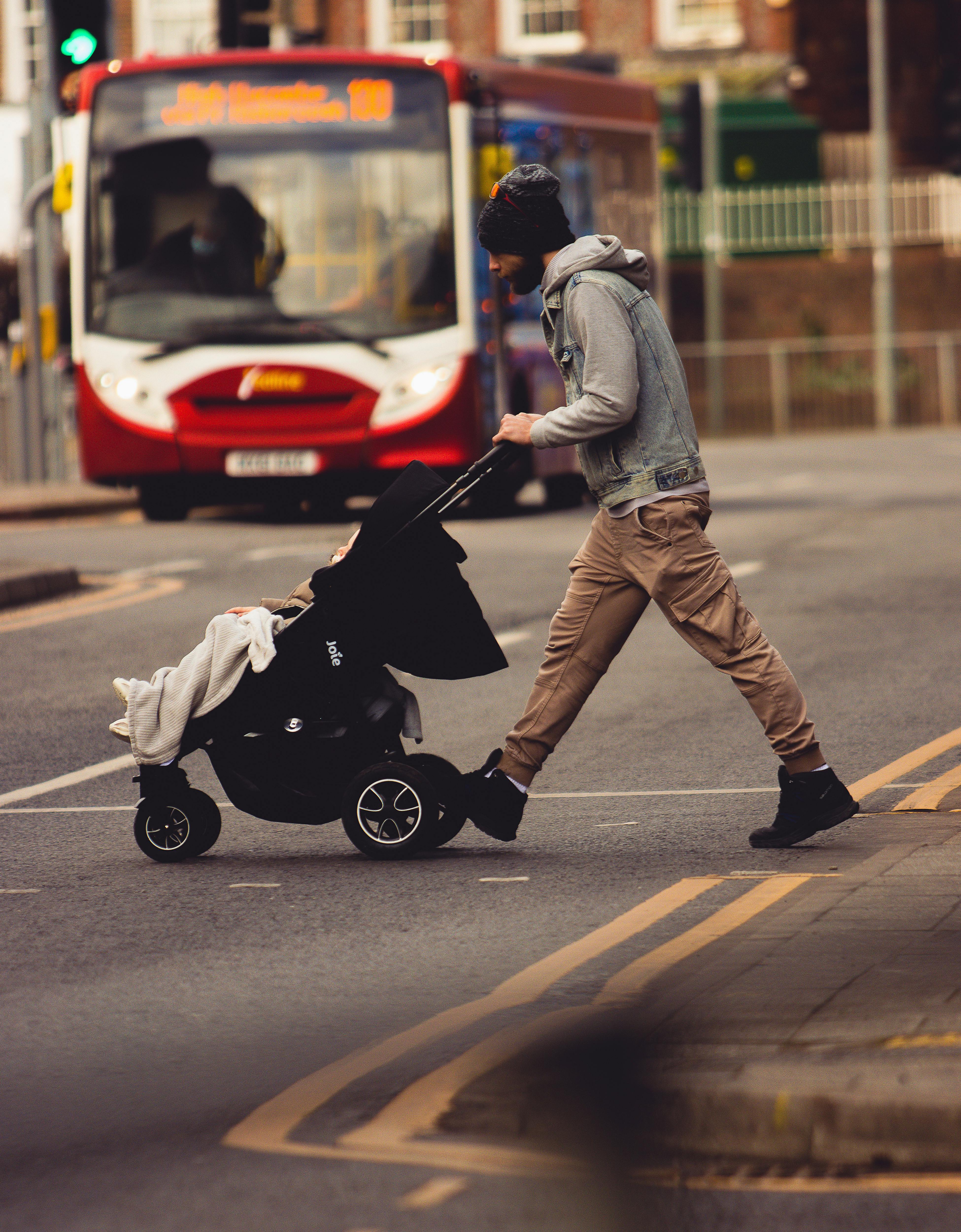 Man Pushing Stroller · Free Stock Photo