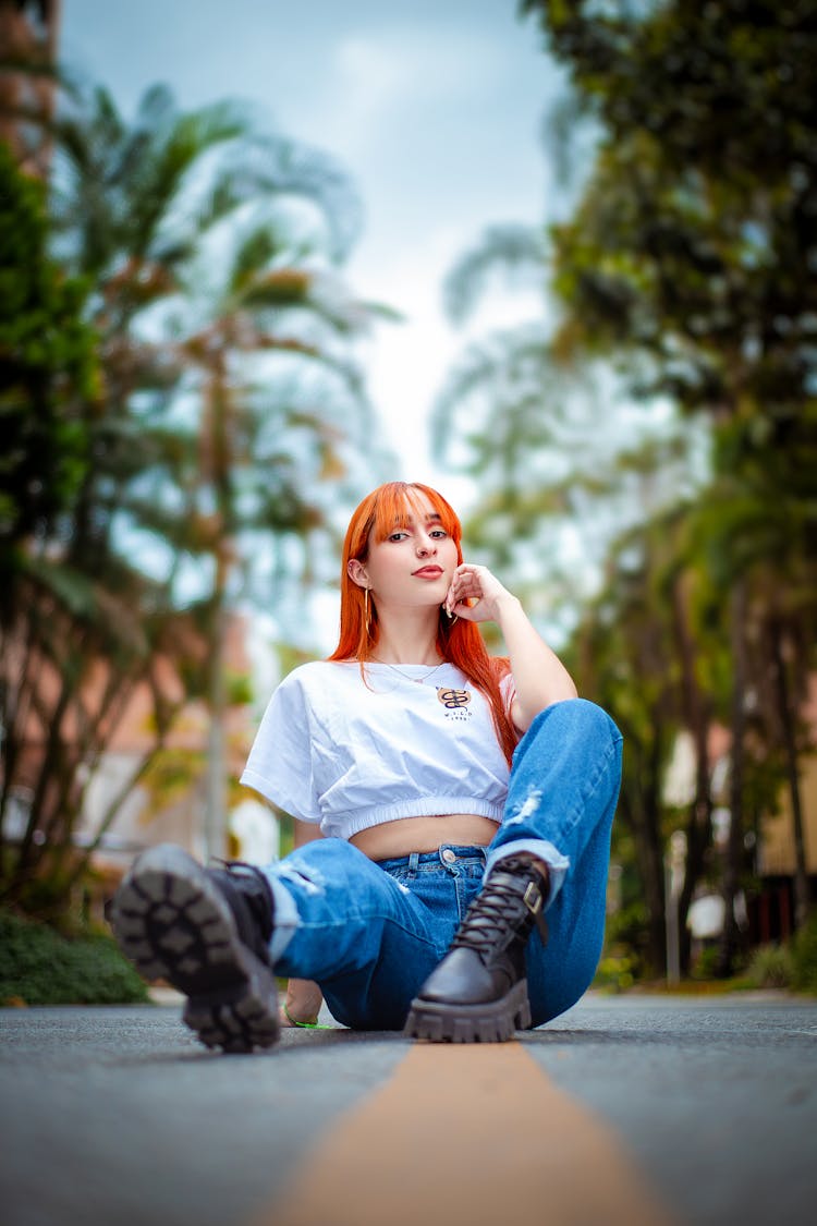 A Woman Sitting On A Road