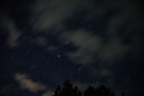 Clouds over Stars on Night Sky