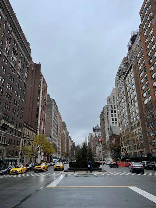Free New York City street scene featuring tall buildings and iconic yellow taxis on a busy day. Stock Photo