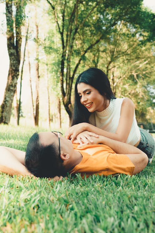 Woman Lying Down on Man in Park