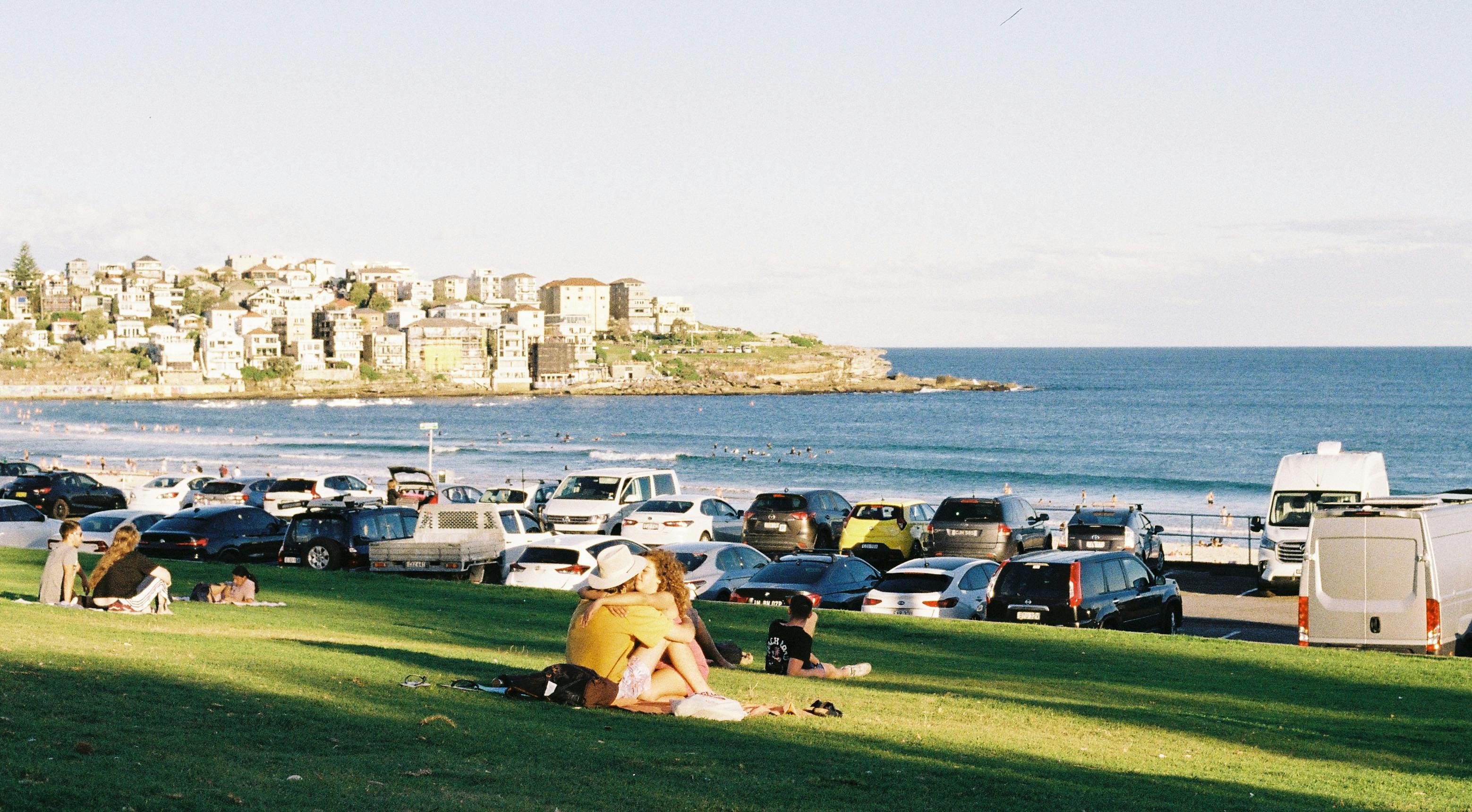 Couples enjoy a sunny day at Bondi Beach, Sydney. Perfect for relaxation and leisure.