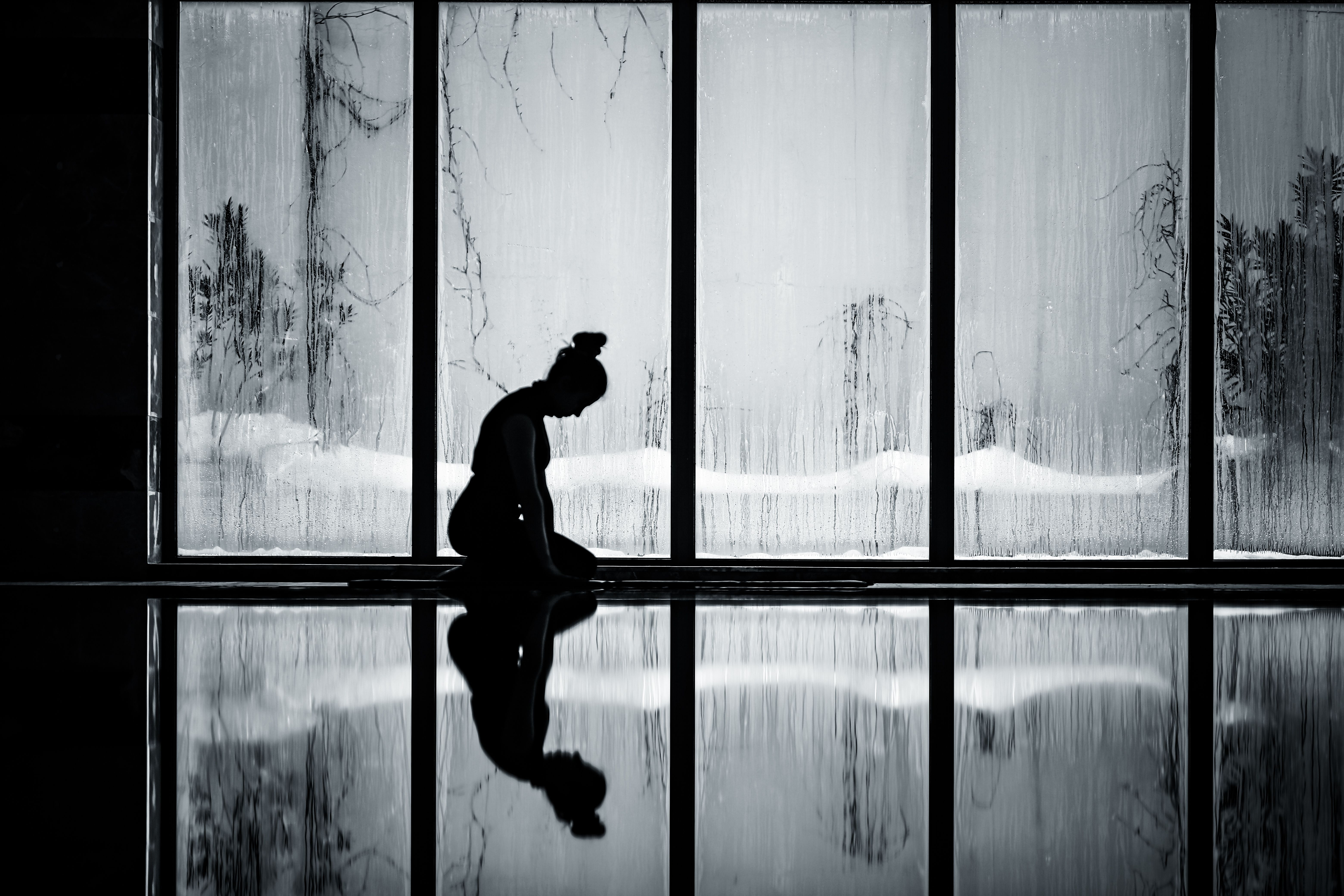 person meditating near a window, balancing action and stillness