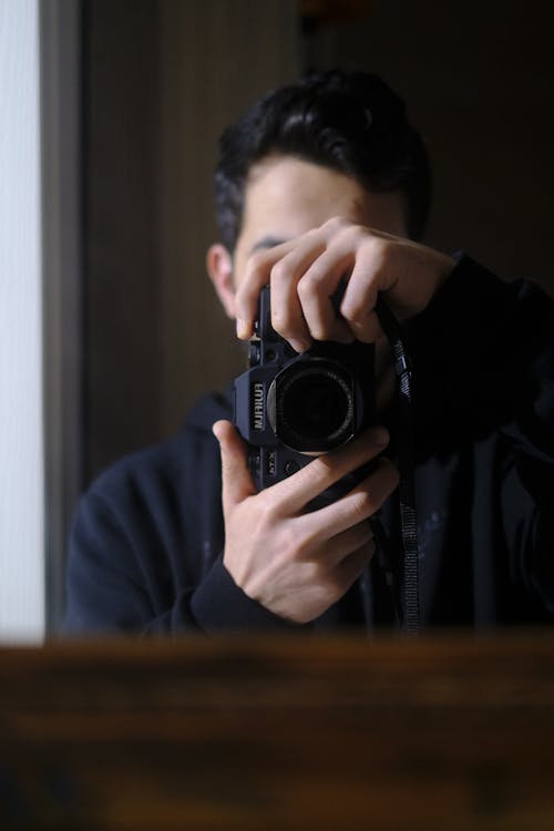 Man Taking a Photograph with a Camera