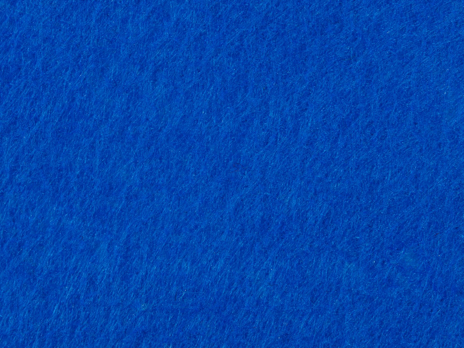 Bright blue textured fabric surface, ideal for backgrounds and design elements.