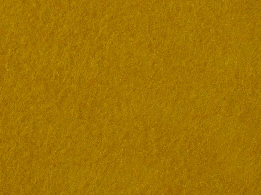 Full-frame macro of a mustard-ochre wool felt surface, dense fibrous texture, even warm lighting, no object, no text, no logo.