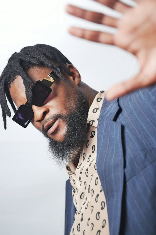 Fashionable, Bearded Man in Sunglasses Posing in Studio 