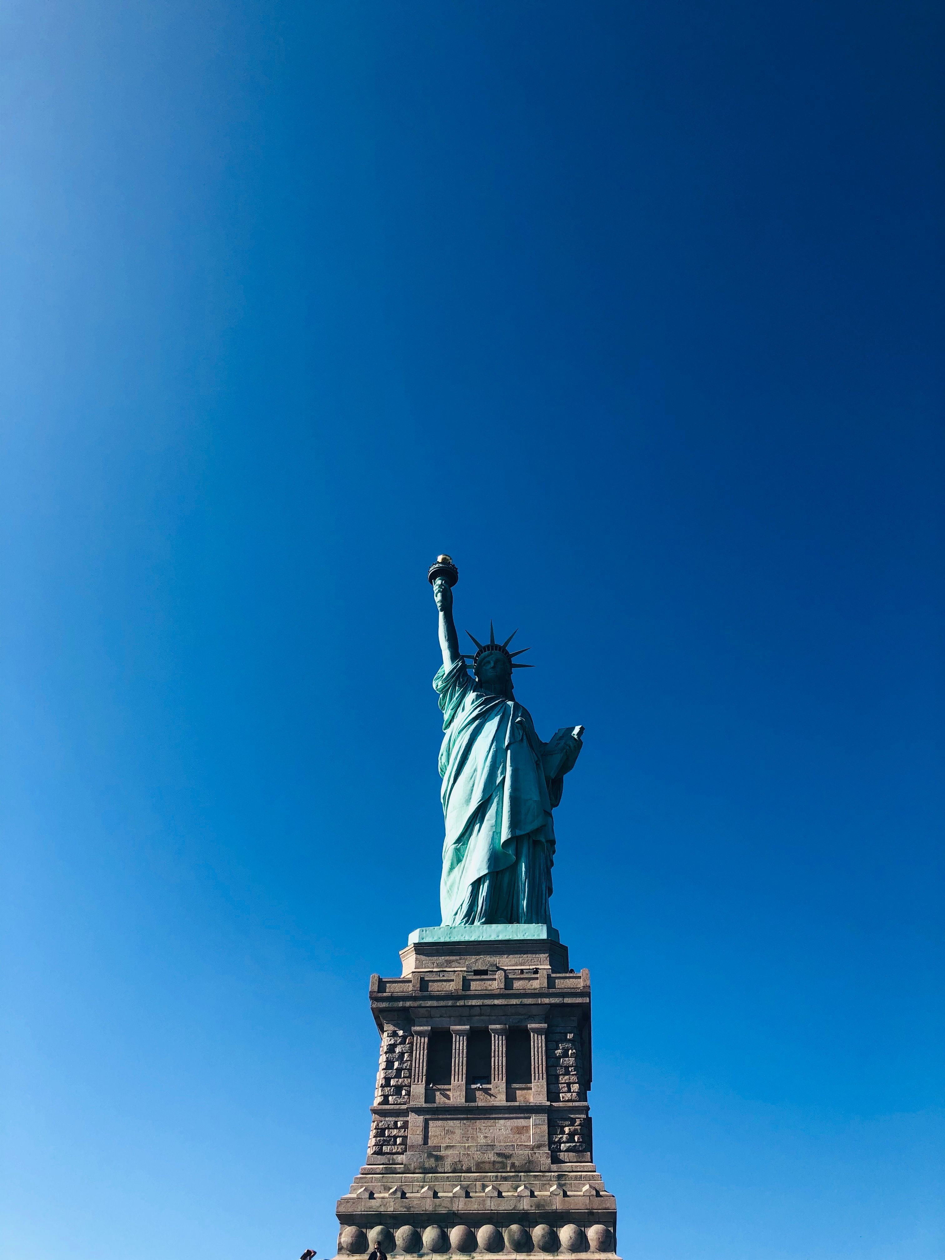 Iconic Statue of Liberty with a vivid blue sky highlighting its grandeur in New York City.