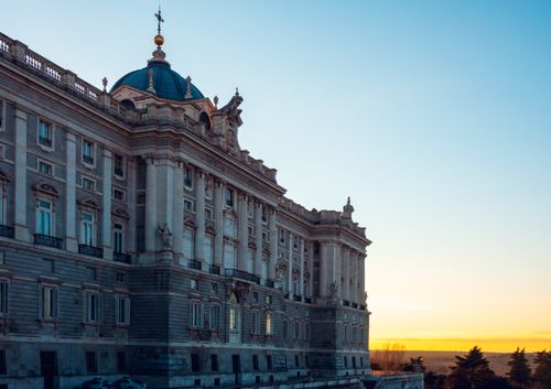 Free Stunning view of the Royal Palace in Madrid with a beautiful sunset backdrop. Stock Photo
