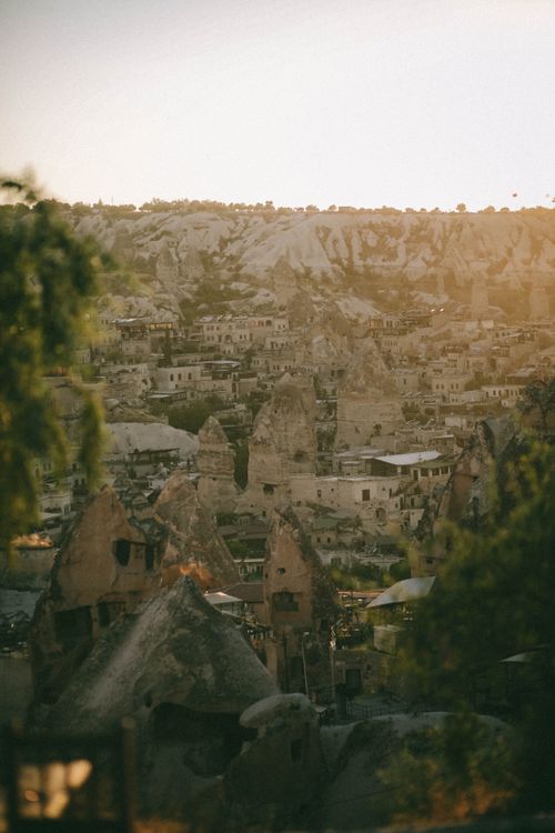 Free A stunning view of Göreme's unique rock formations at sunset in Cappadocia, Türkiye. Stock Photo