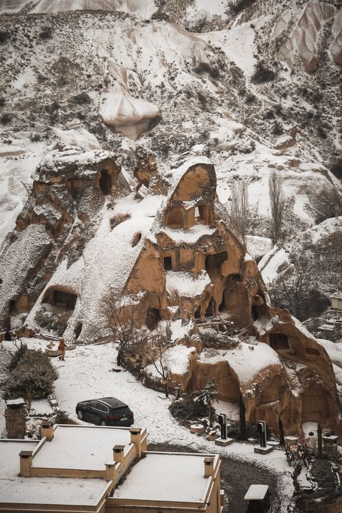 Free Explore the snow-laden cave houses of Cappadocia in this stunning winter landscape. Stock Photo