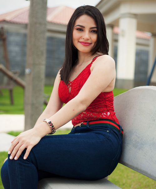 Free Stylish woman in jeans and red lace blouse, posing outdoors in Managua, Nicaragua. Stock Photo