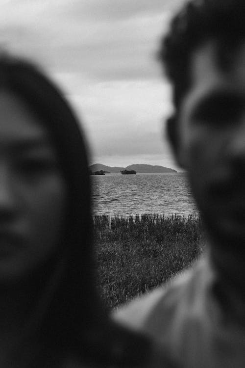 Sea Coast behind Man and Woman Face in Black and White