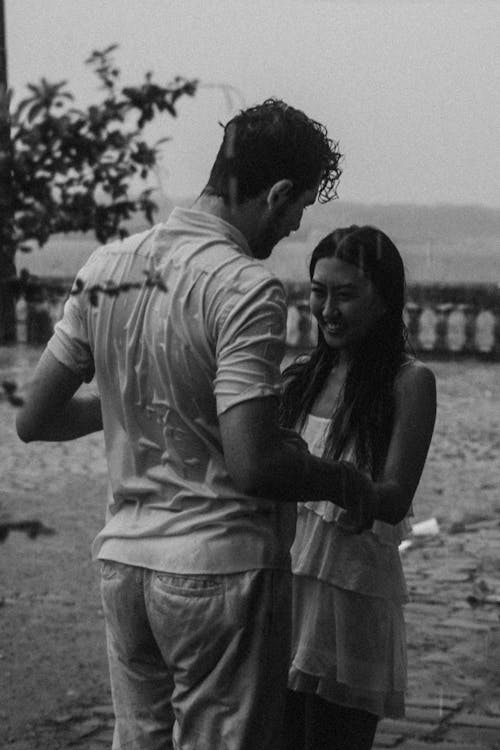 Smiling Couple Holding Hands in Black and White