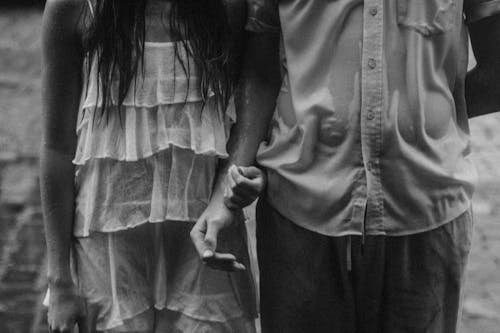 Woman and Man Holding Hands in Black and White 