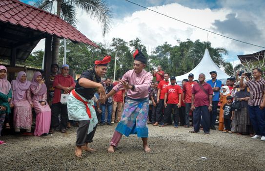 A lively outdoor cultural celebration with traditional dance and vibrant attire.