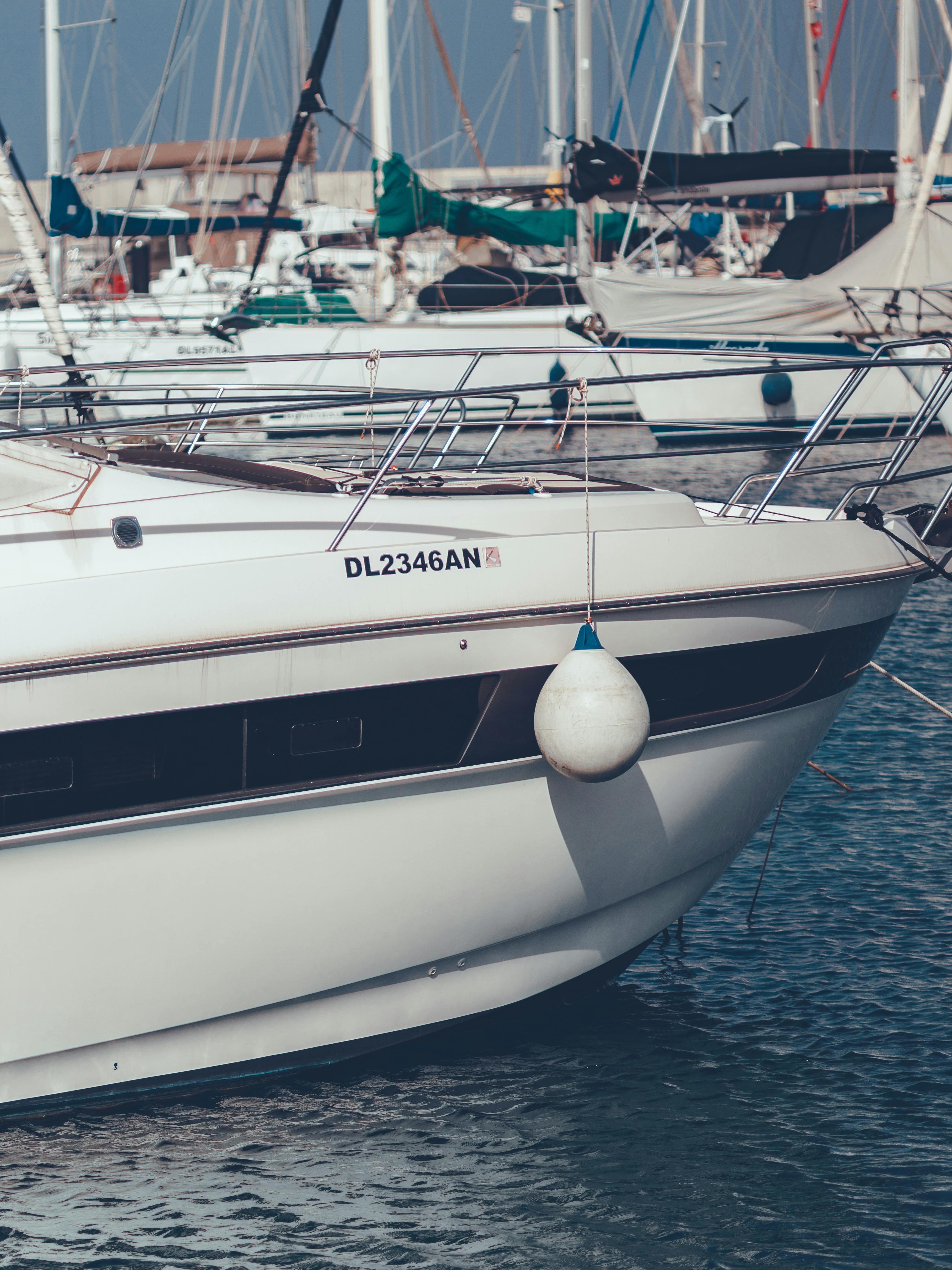 Free Close-up view of a white yacht moored in Γιαλούσα marina, captured in daylight with surrounding boats. Stock Photo