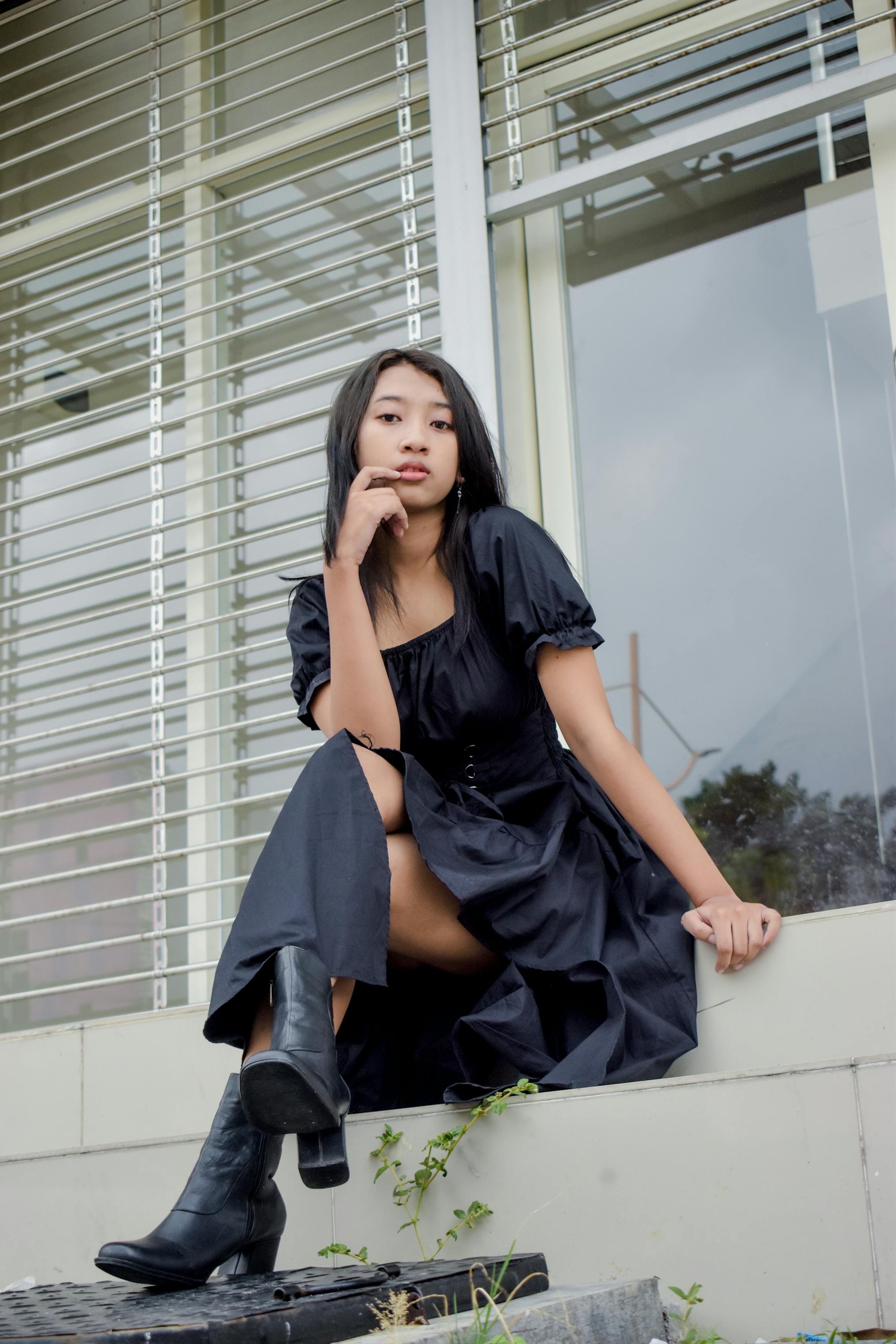 Woman in Boots Sitting by Desk with Laptop · Free Stock Photo