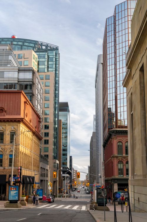 Free Explore the bustling urban landscape of Ottawa featuring tall modern skyscrapers and historic buildings. Stock Photo