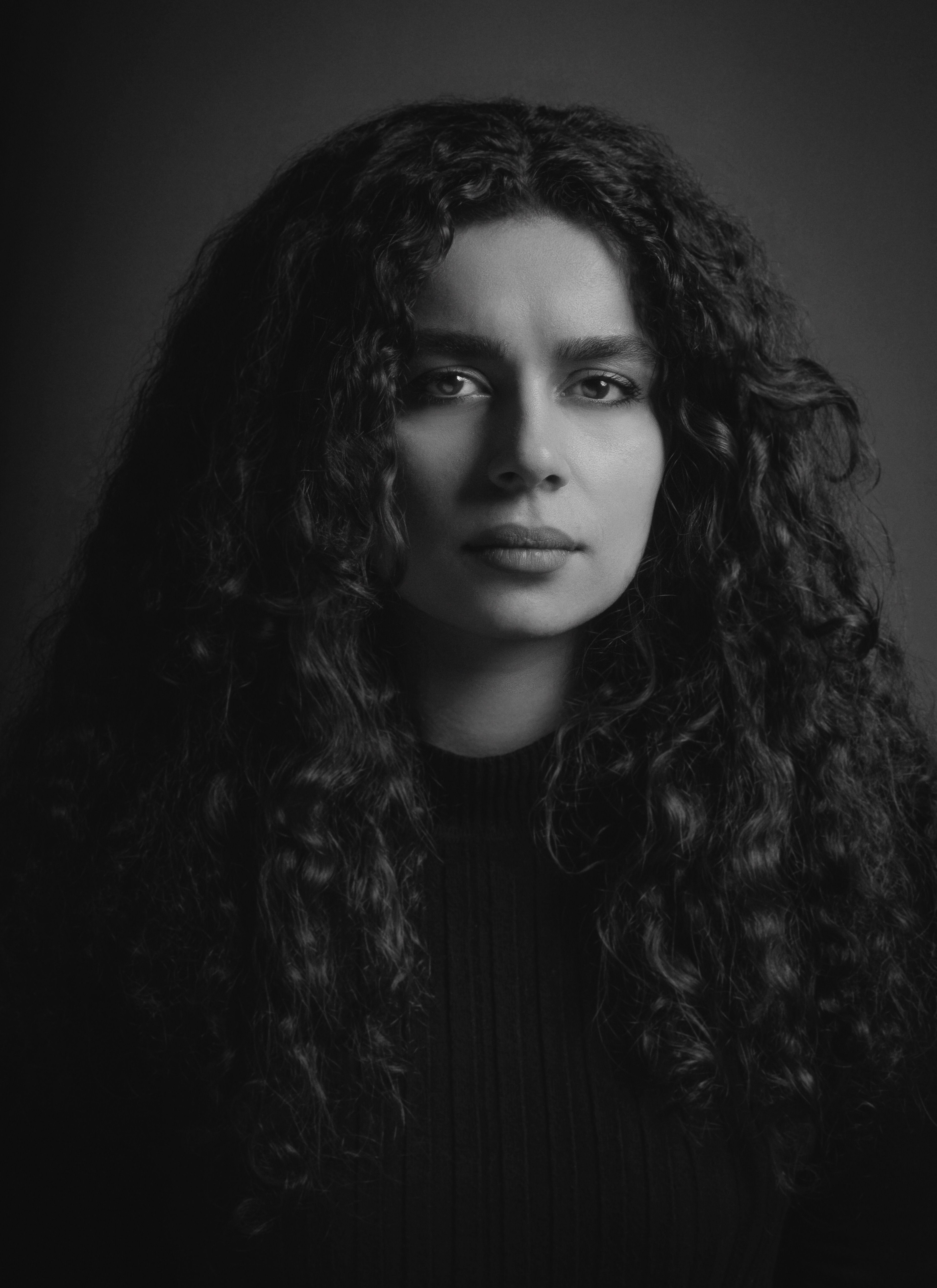 Portrait of Woman with Curly Hair in Black and White · Free Stock Photo