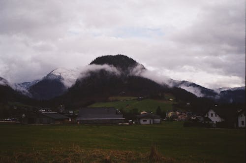 Photo of a Mountain Village against a Cloudy Sky 