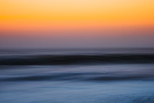 Vibrant sunset over the serene Maravanthe ocean in Karnataka, India.