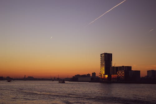 Glass Building by the Sea During Sunset 