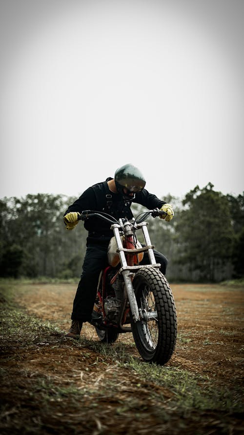 Photo of a Man Driving a Dirt Bike