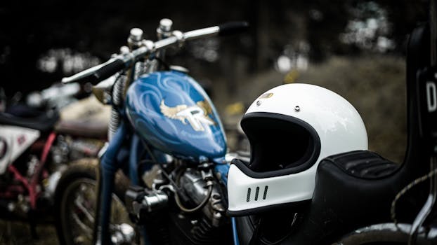 Stylish vintage motorcycle with helmet in an outdoor setting, capturing a classic biker vibe.