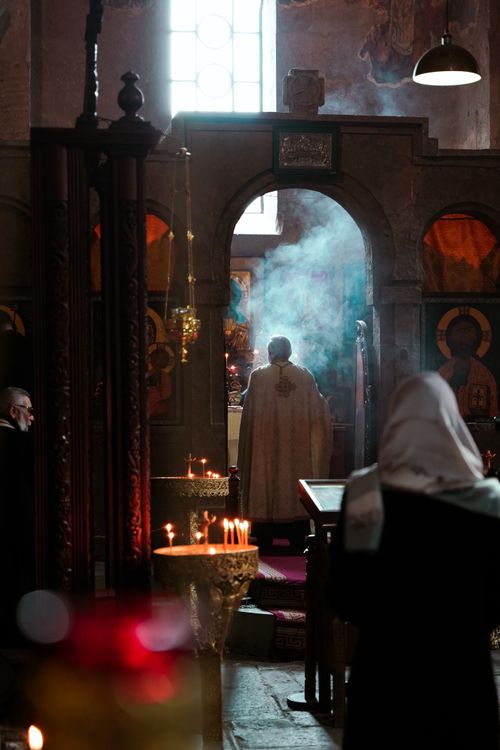 Free A priest conducts a religious ceremony in a Tbilisi church with candles and smoke. Stock Photo